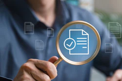 A man holds up a magnifying glass to a superimposed image of a document with a check mark pictured next to it. The image symbolizes a review and approval process.