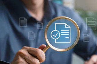 A man holds up a magnifying glass to a superimposed image of a document with a check mark pictured next to it. The image symbolizes a review and approval process.