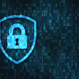 Glowing blue padlock with a shield, symbolizing cybersecurity.