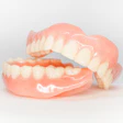 Set of dentures, with the upper prosthesis resting on the mandibular prosthesis.