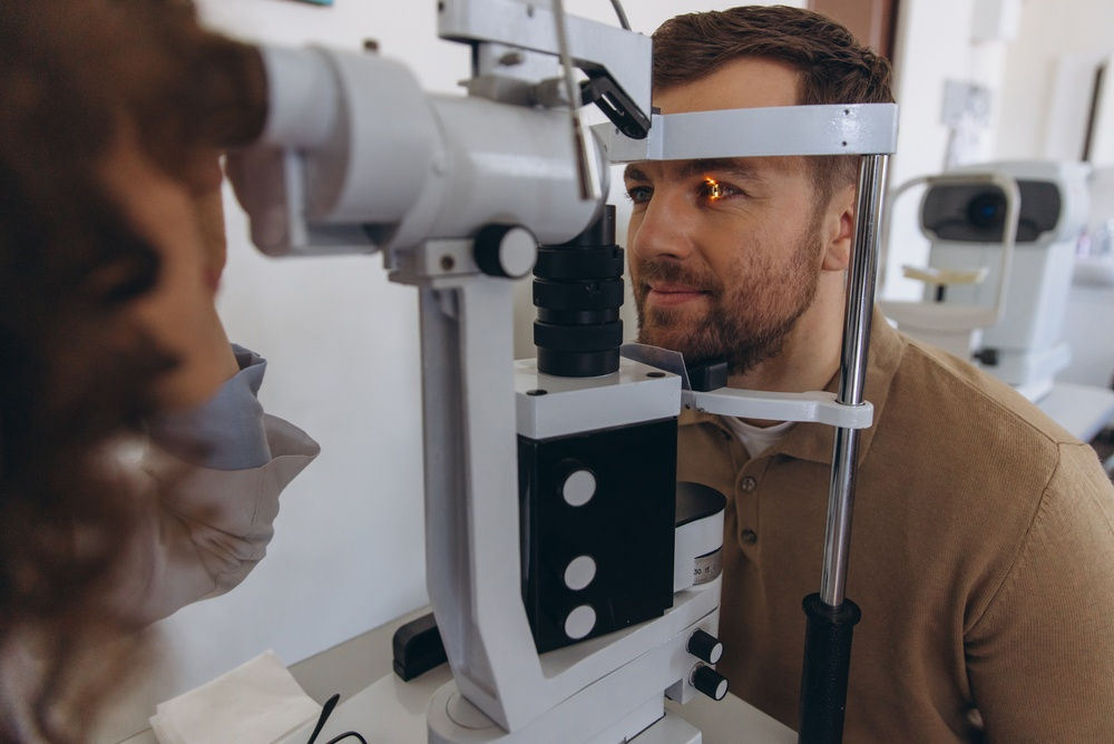 A male patient has his eyes examined by an opthomologist.