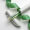 Medical GLP-1 syringe with green measuring tape wrapped around it on a white background.