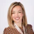 Professional headshot of smiling woman wearing brown polka dot blazer with patterned scarf Headshot