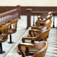 Empty wood jury chairs are shown.
