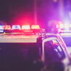 Police emergency vehicle lights flashing red and blue at night.